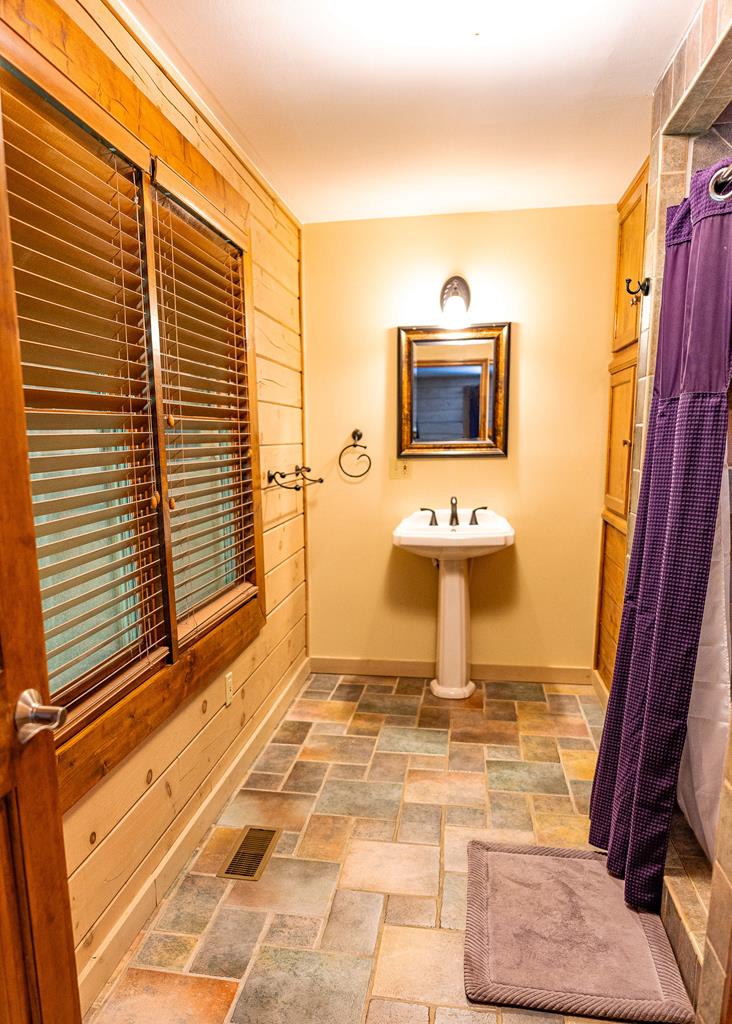 192 Fingerboard Road Reliance, TN 37369 - Photo 16 of 57 a living room with a table and a flat screen tv