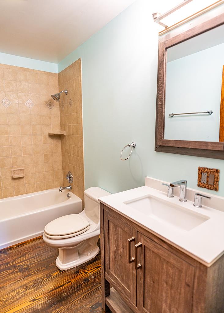 192 Fingerboard Road Reliance, TN 37369 - Photo 19 of 57 a bathroom with a sink a toilet a mirror and shower