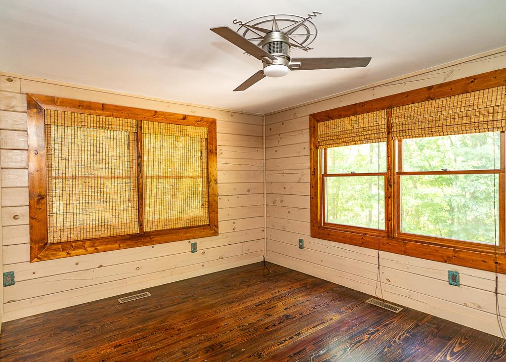 192 Fingerboard Road Reliance, TN 37369 - Photo 20 of 57 a view of an empty room with wooden floor and a window