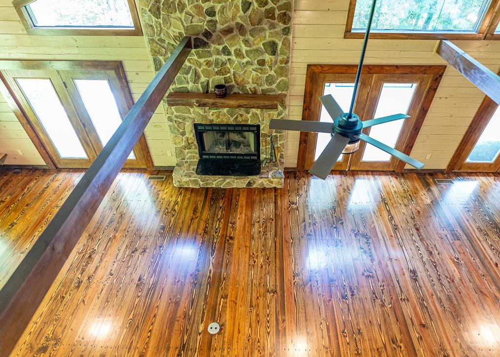 192 Fingerboard Road Reliance, TN 37369 - Photo 23 of 57 a living room with wooden floors and a fireplace