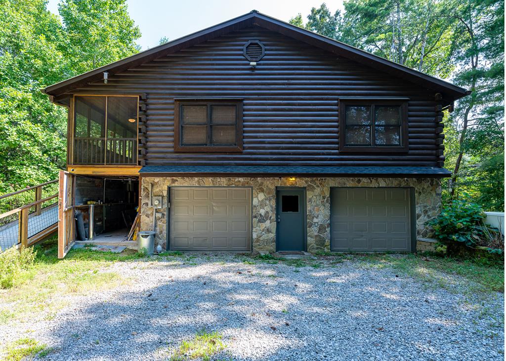 192 Fingerboard Road Reliance, TN 37369 - Photo 27 of 57 a front view of a house with a yard and garage