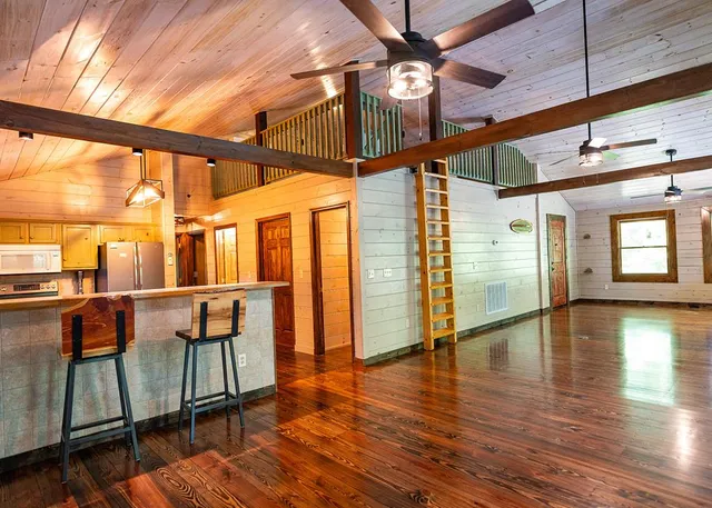 a view of interior space with wooden floor and windows