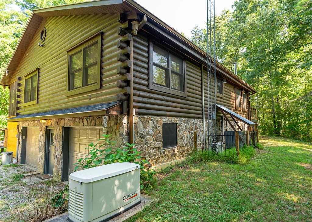 192 Fingerboard Road Reliance, TN 37369 - Photo 48 of 57 a backyard of a house with large trees and plants