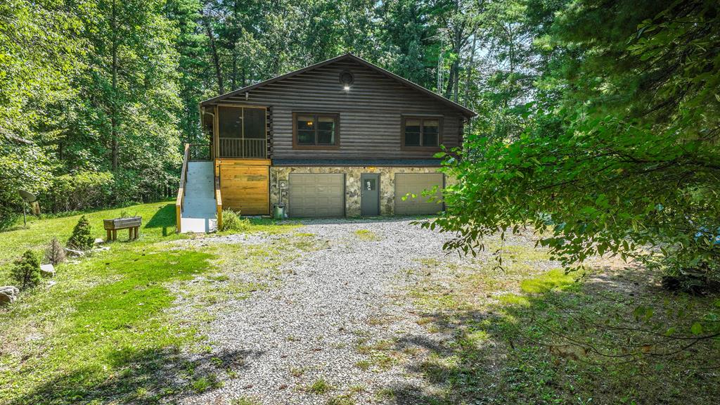 192 Fingerboard Road Reliance, TN 37369 - Photo 53 of 57 a front view of a house with a yard and trees