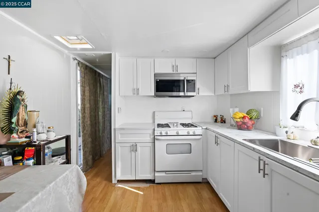 a kitchen with a sink a stove and cabinets