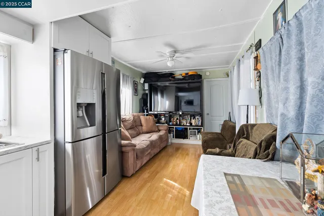 a living room with stainless steel appliances furniture and a rug