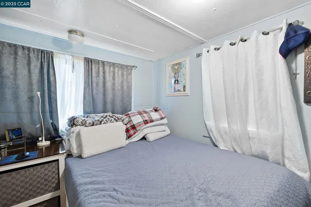 a bed room with a bed and a mirror