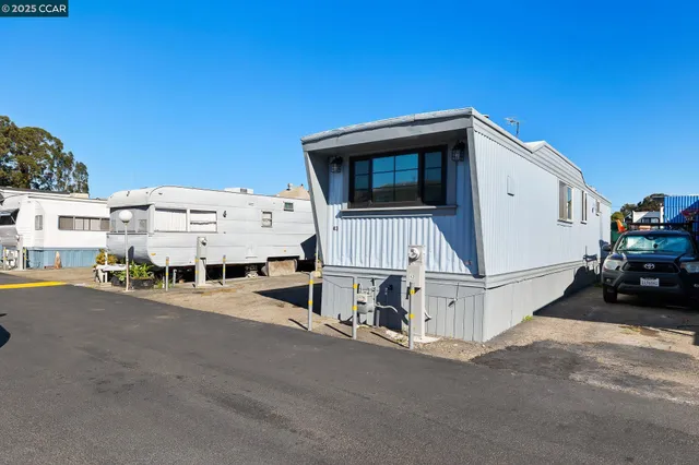 a view of a white house with a street