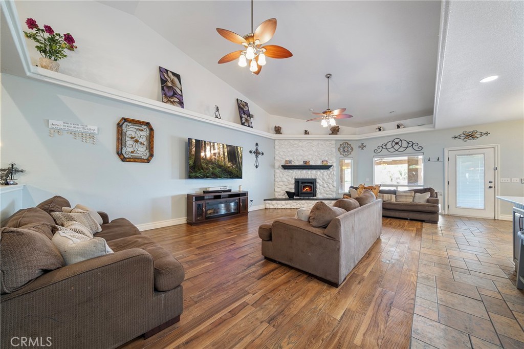 7172 Jargon Road Hesperia, CA 92344 - Photo 9 of 75 a living room with furniture a flat screen tv and kitchen view