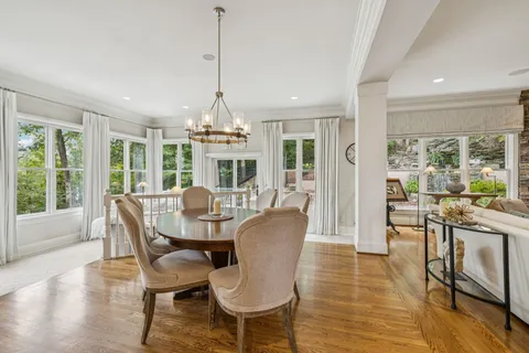 a spacious bedroom with a bed and a chandelier
