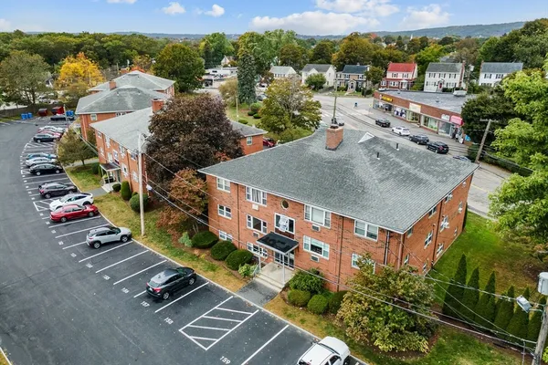 an aerial view of residential houses with outdoor space