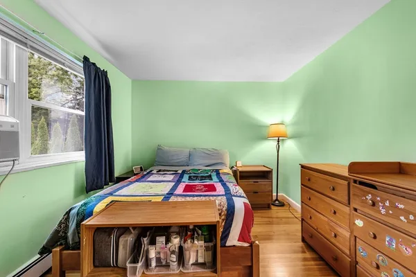 a bedroom with a bed a table and chair