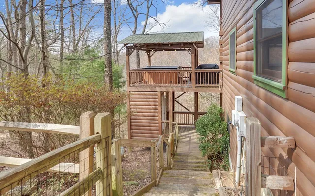 a room with lots of white furniture and a rug