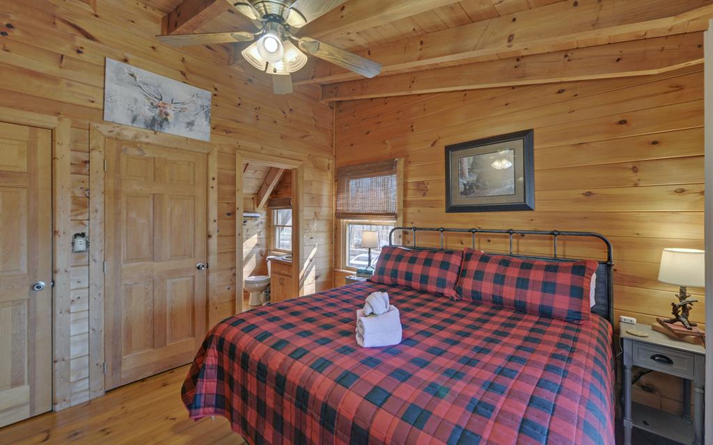 184 Smith Hill Road Blue Ridge, GA 30513 - Photo 36 of 36 a bedroom with a bed and a lamp on dresser