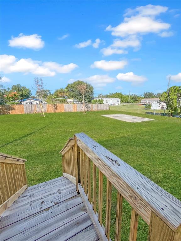6027 Quince Street Punta Gorda, FL 33950 - Photo 14 of 18 a view of a balcony with wooden floor and city view