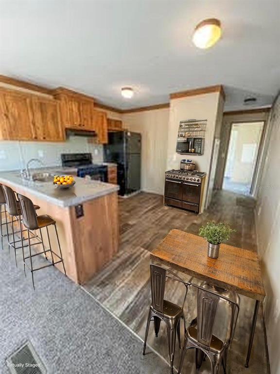 6027 Quince Street Punta Gorda, FL 33950 - Photo 15 of 18 a kitchen with a stove a sink and a refrigerator