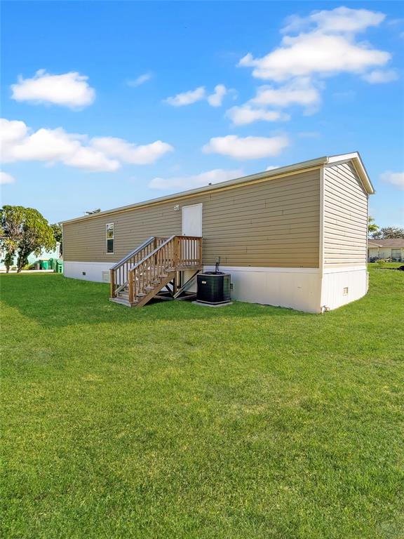 6027 Quince Street Punta Gorda, FL 33950 - Photo 2 of 18 a view of a backyard with plants and large trees