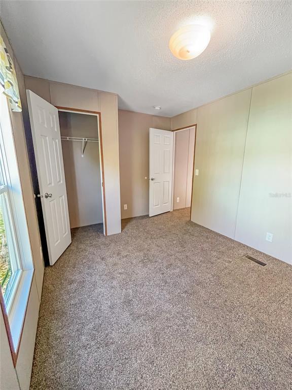 6027 Quince Street Punta Gorda, FL 33950 - Photo 8 of 18 an empty room with windows and entrance