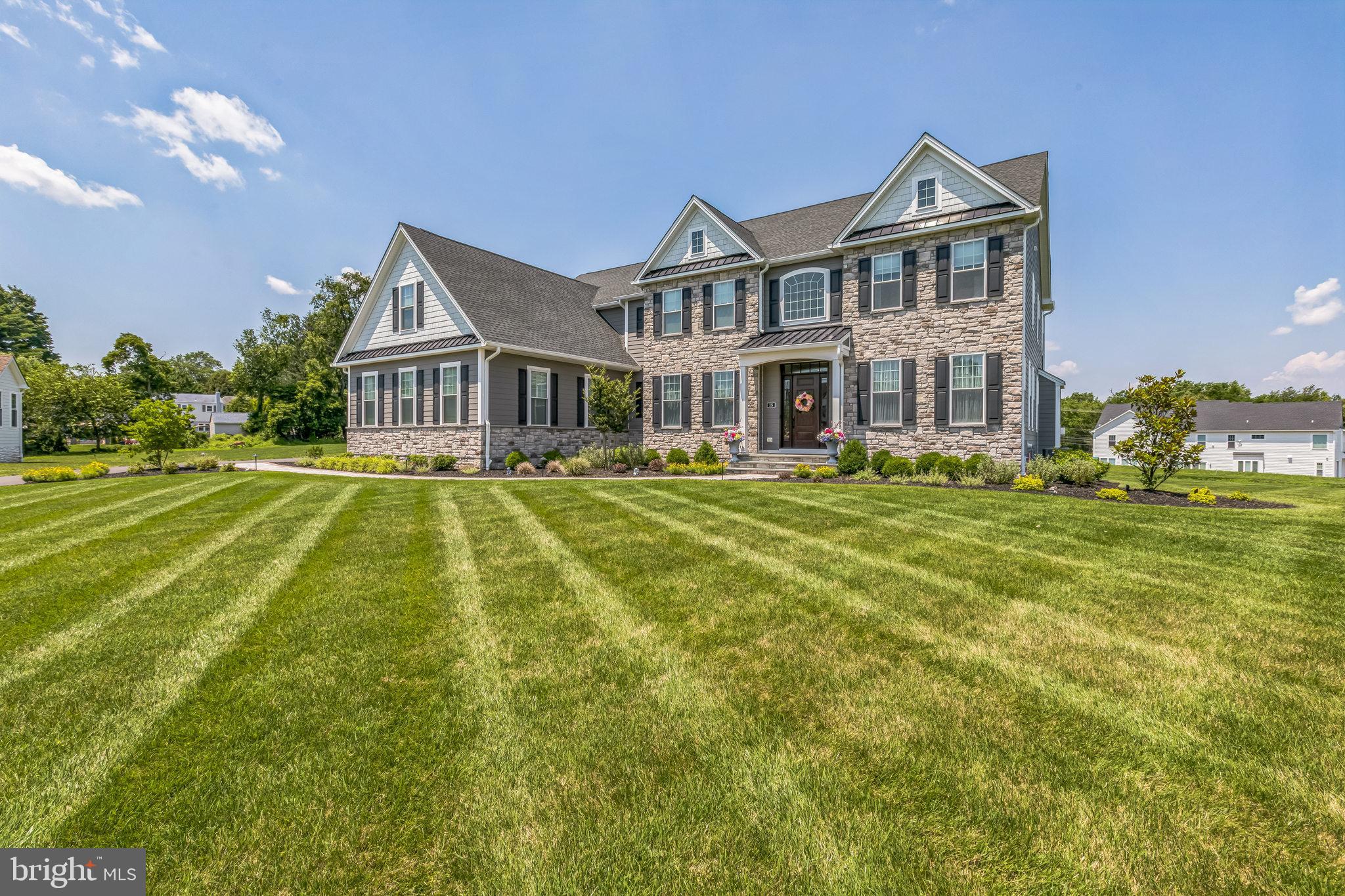 15 Marquis Ridge Holland, PA 18966 - Photo 4 of 83 a view of a big house with a big yard and potted plants
