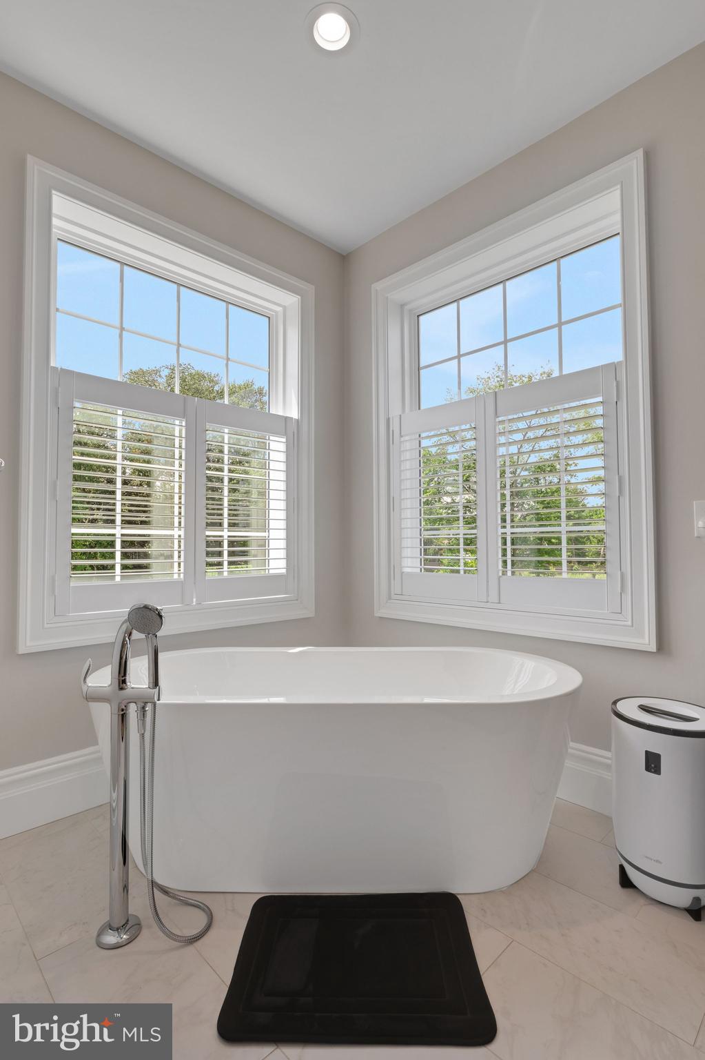 15 Marquis Ridge Holland, PA 18966 - Photo 50 of 83 a white bath tub sitting in a bathroom next to a window