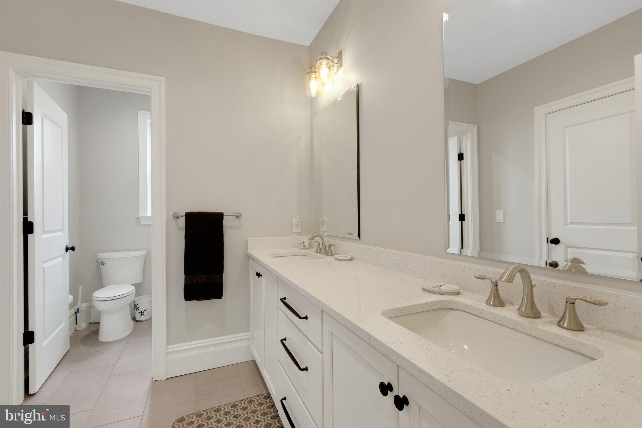 15 Marquis Ridge Holland, PA 18966 - Photo 55 of 83 a bathroom with a sink toilet double vanity and mirror