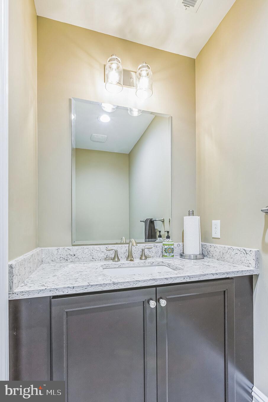 15 Marquis Ridge Holland, PA 18966 - Photo 58 of 83 a bathroom with a granite countertop sink and a mirror