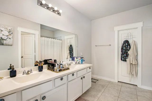 a bathroom with double sink and a mirror