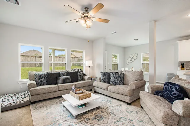 a living room with furniture and a large window