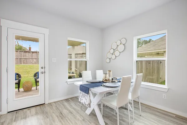a view of a dining room with furniture and a window