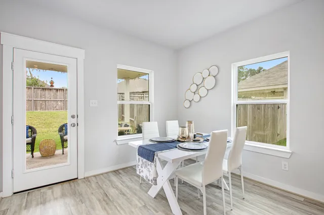 a view of a dining room with furniture and a window