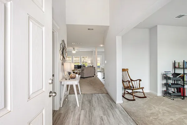 a view of a livingroom with furniture and a hardwood floor