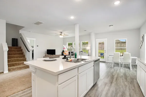 a open kitchen with sink stove and cabinets