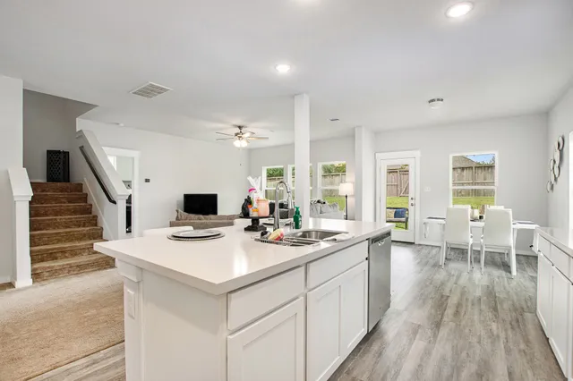a open kitchen with sink stove and cabinets