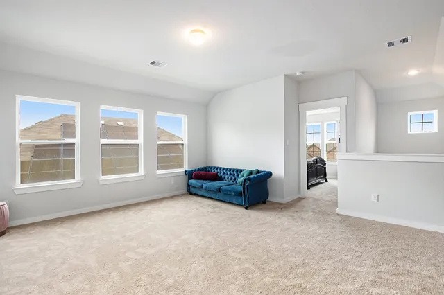 an entryway and livingroom with furniture