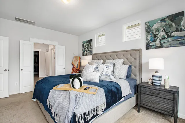 a bedroom with bed and cabinet