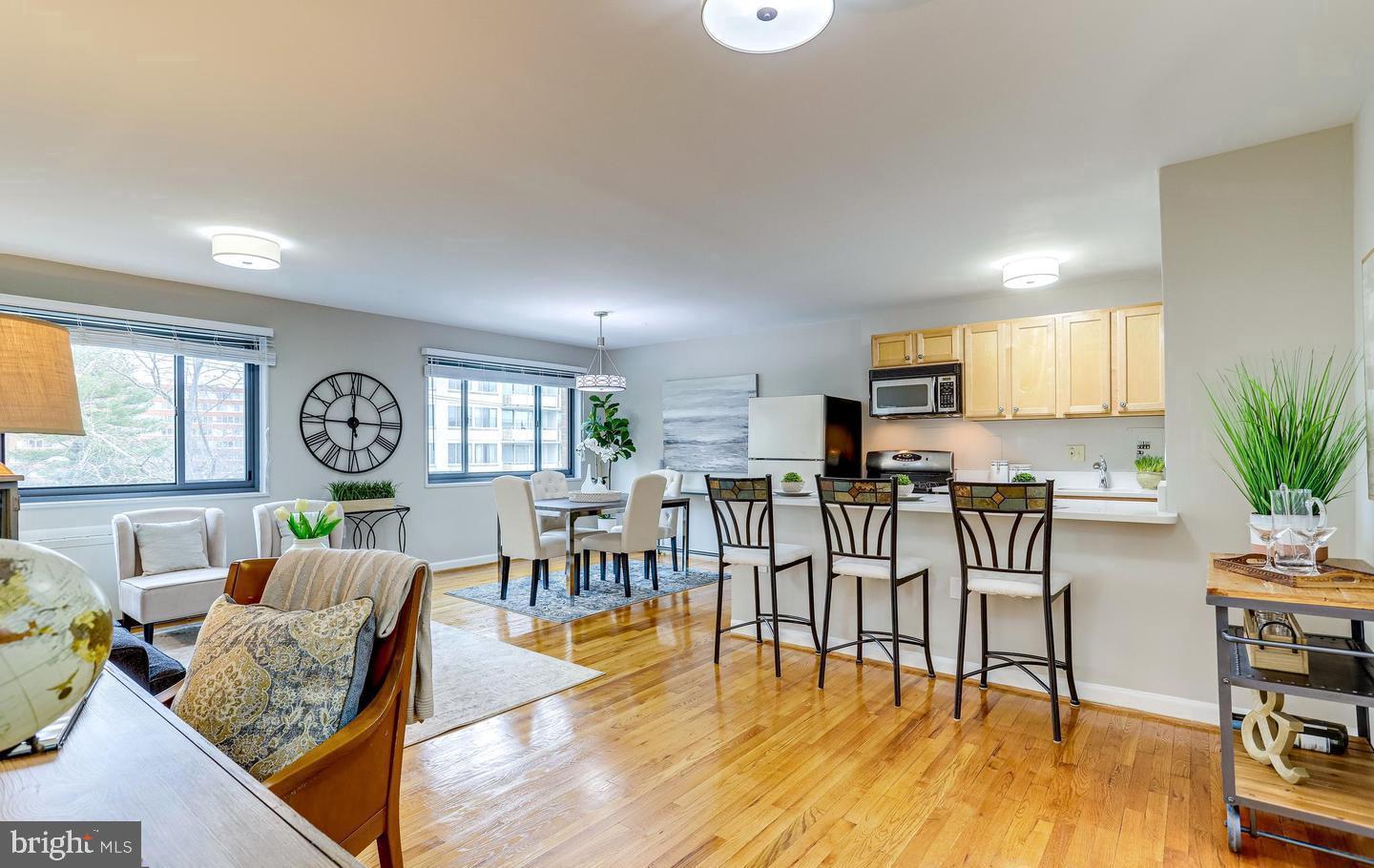 1200 South Arlington Ridge Road, Unit 608 Arlington, VA 22202 - Photo 2 of 16 a living room with furniture a dining table and a large window