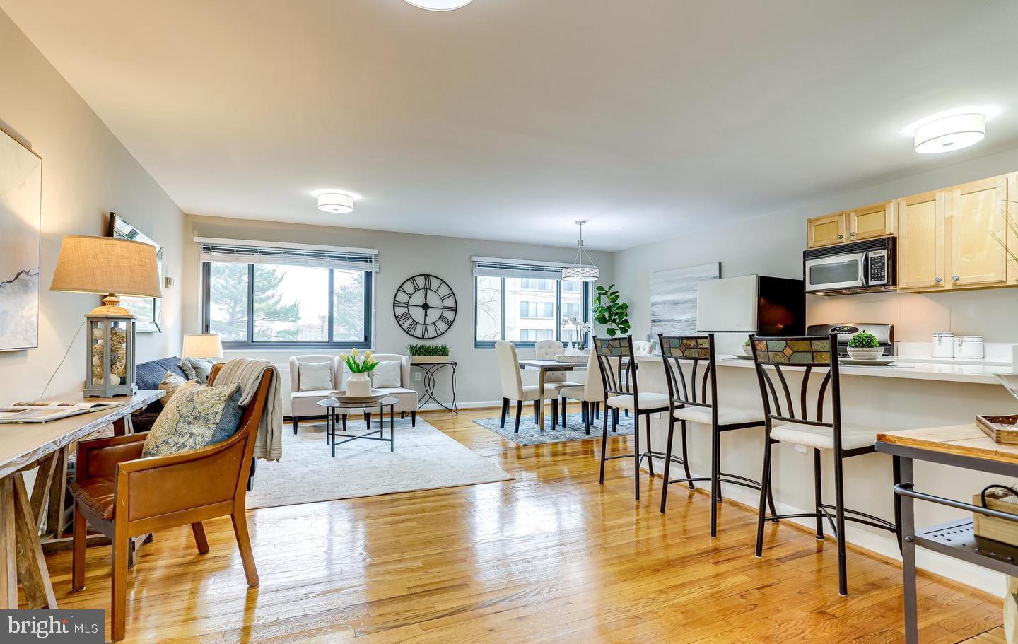 1200 South Arlington Ridge Road, Unit 608 Arlington, VA 22202 - Photo 3 of 16 a living room with furniture and kitchen view with wooden floor
