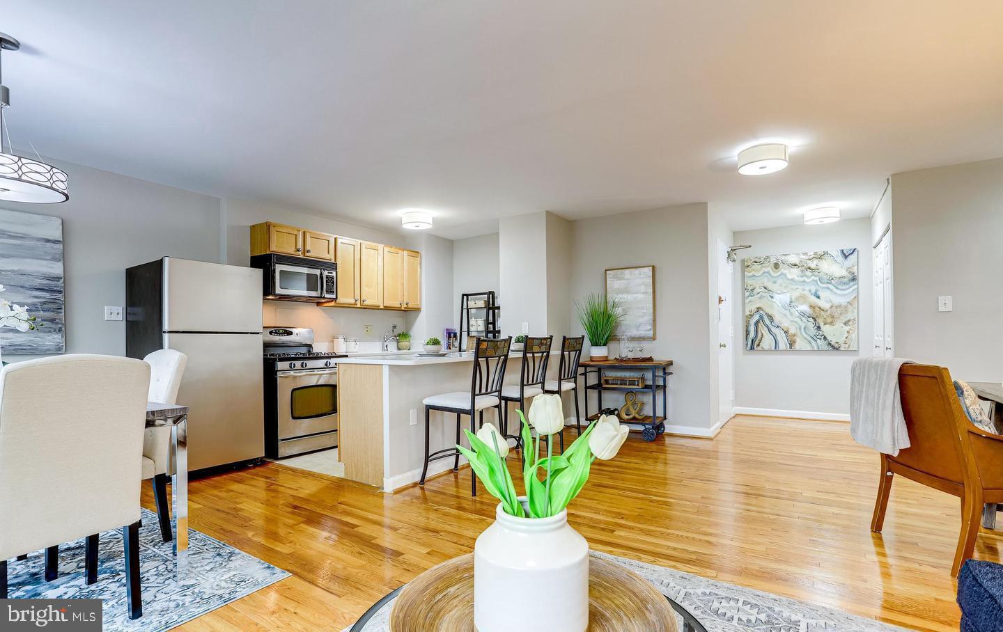 1200 South Arlington Ridge Road, Unit 608 Arlington, VA 22202 - Photo 7 of 16 a living room with stainless steel appliances furniture a dining table and kitchen view