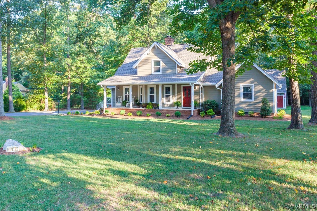 5710 Deep Forest Road Richmond, VA 23237 - Photo 2 of 40 a front view of a house with a yard table and chairs