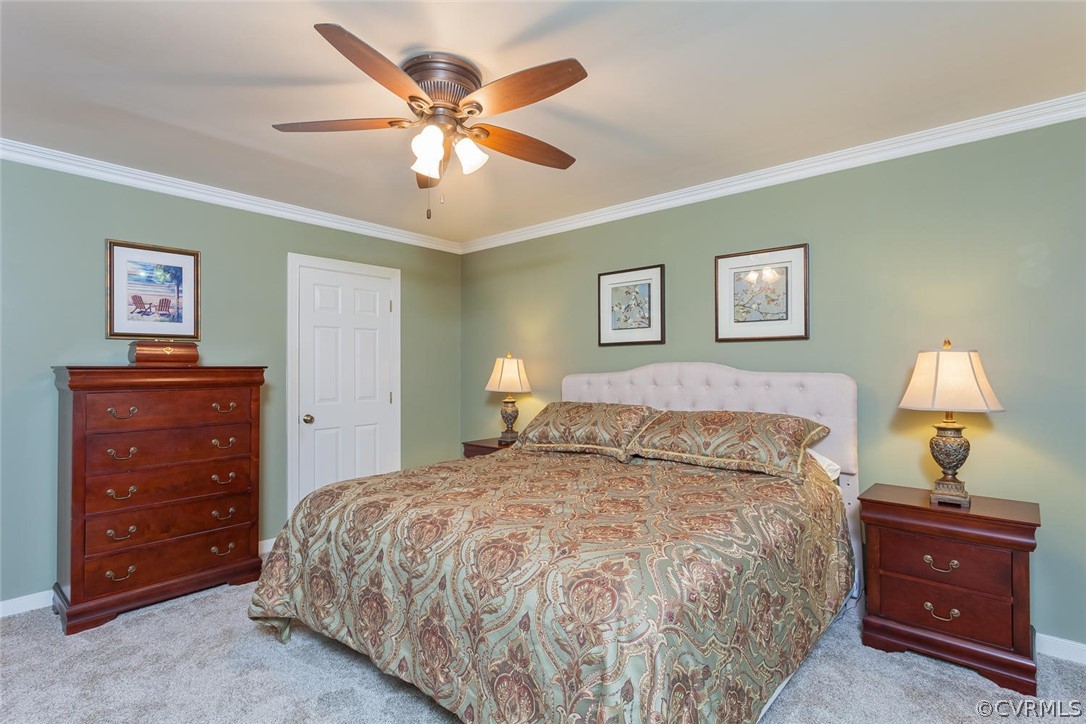 5710 Deep Forest Road Richmond, VA 23237 - Photo 26 of 40 a bedroom with a bed and a lamp on dresser