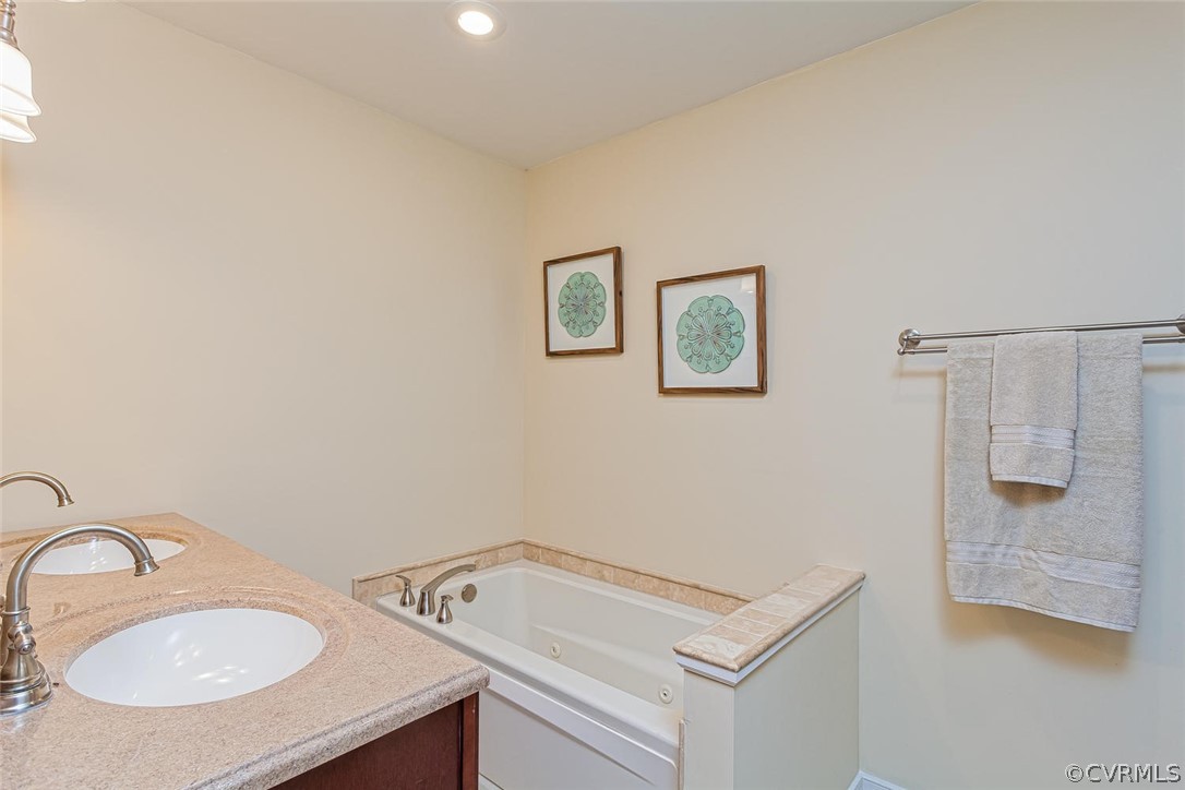 5710 Deep Forest Road Richmond, VA 23237 - Photo 29 of 40 a bathroom with a sink and a mirror