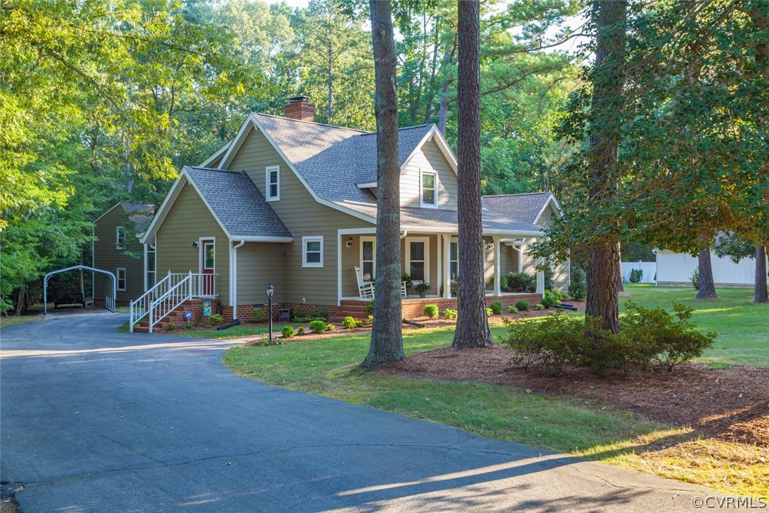 5710 Deep Forest Road Richmond, VA 23237 - Photo 3 of 40 a view of a house with garden and trees