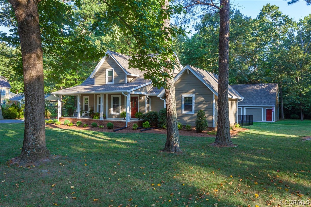 5710 Deep Forest Road Richmond, VA 23237 - Photo 4 of 40 a front view of a house with a yard table and chairs