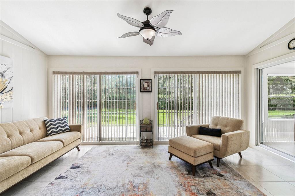 12202 Aaron Terrace Trinity, FL 34655 - Photo 10 of 41 a living room with furniture and a large window with balcony view