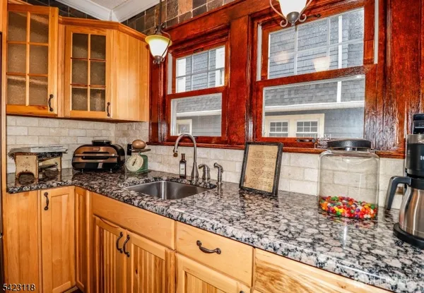a kitchen with granite countertop a sink and a counter top space