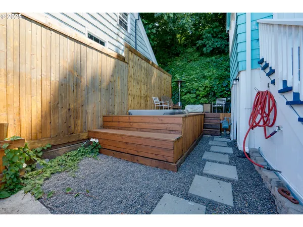 a backyard of a house with a yard fountain and outdoor seating