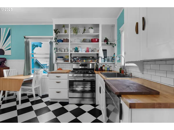 a kitchen with a sink a stove and cabinets
