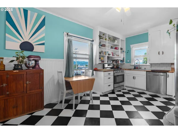 a kitchen with a checkered floor and white cabinets