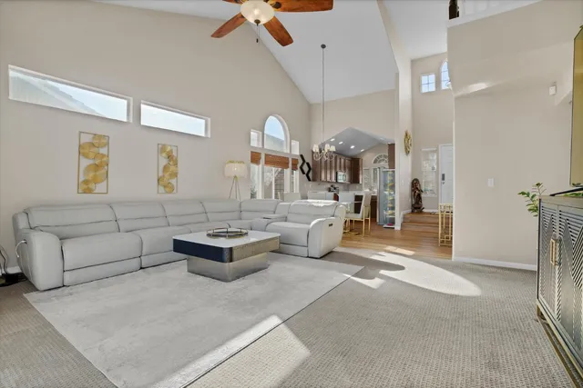 a living room with furniture and a chandelier