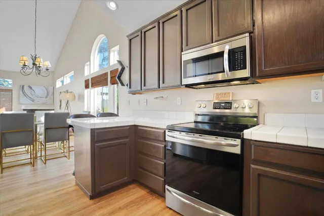 a kitchen with stainless steel appliances a stove microwave and cabinets